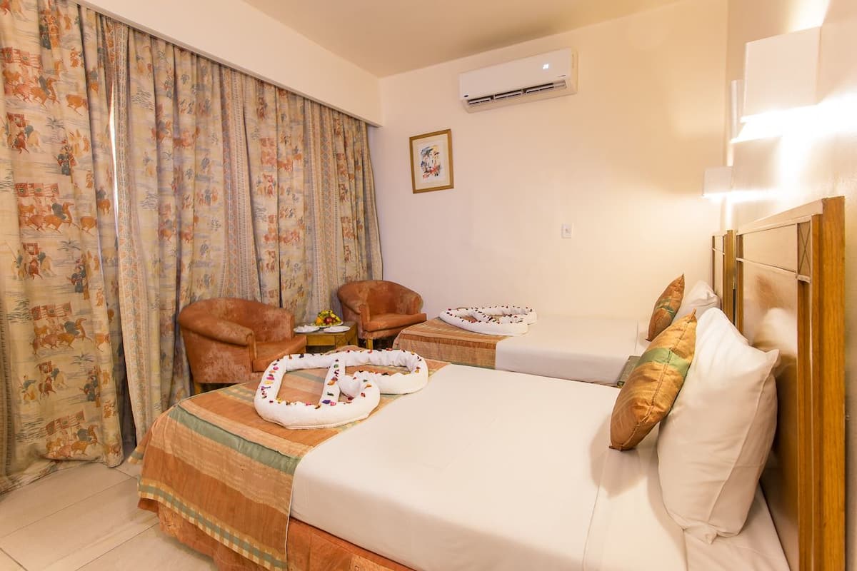Superior Twin Room | Minibar, in-room safe, iron/ironing board, bed sheets