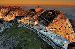 A modern hotel with a unique terraced design, situated on a mountain slope with panoramic views. - Hotel Pilatus Kulm (Kriens)
