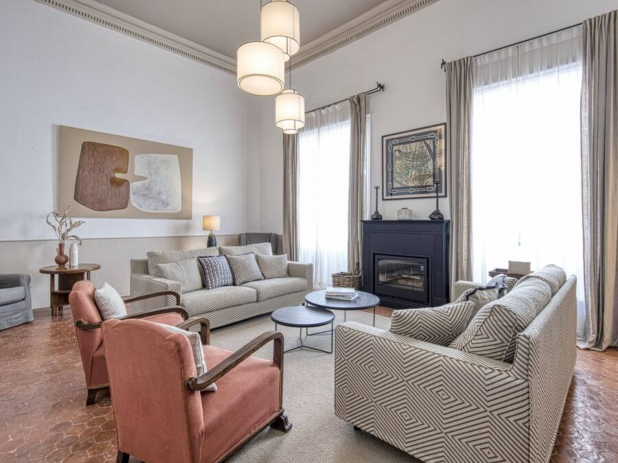 A spacious living room with a fireplace, two sofas, a coffee table, and a rug.