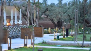 A landscaped outdoor area with seating, planters, and lighting fixtures.