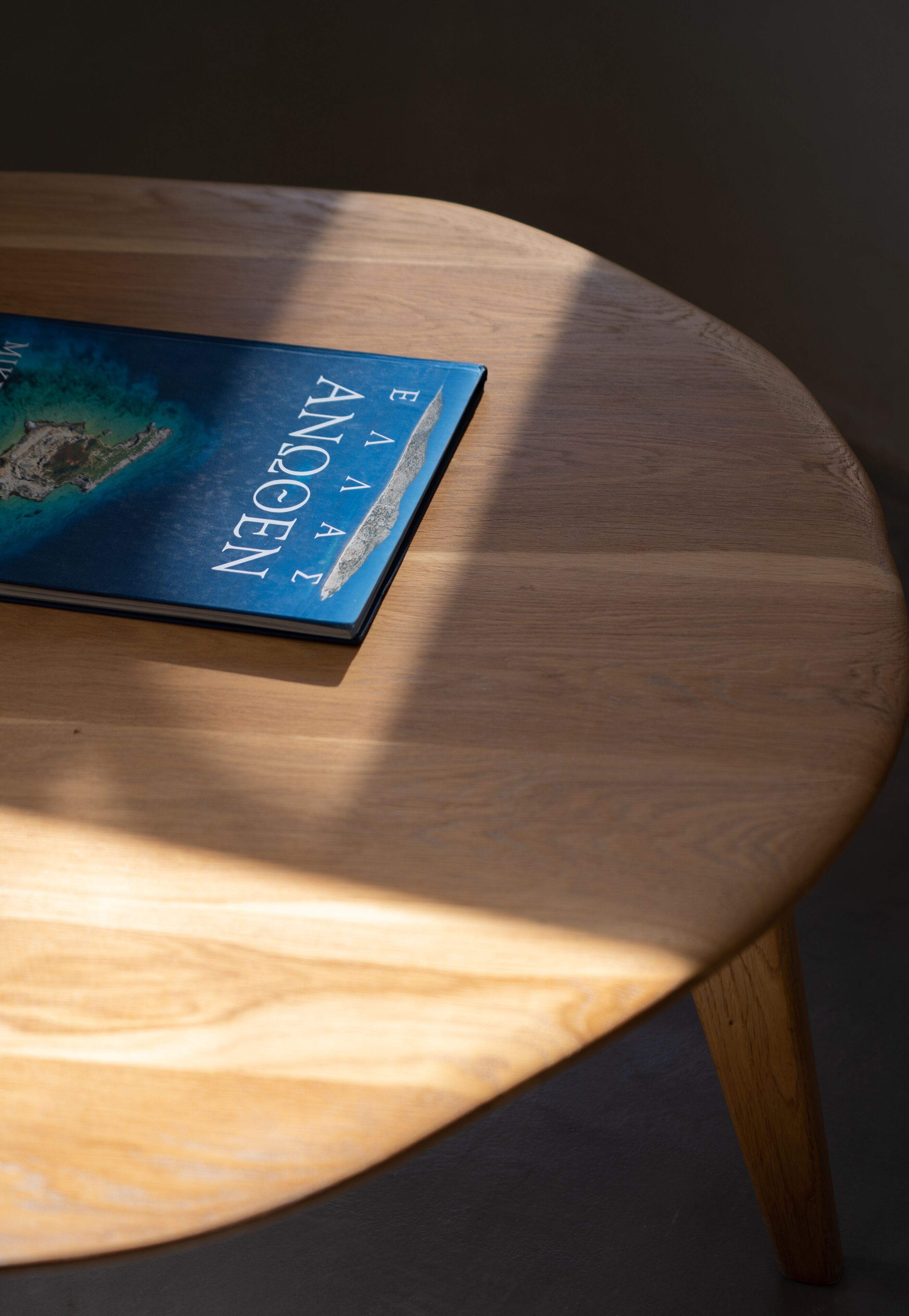A book titled "A POEM" on a wooden table.