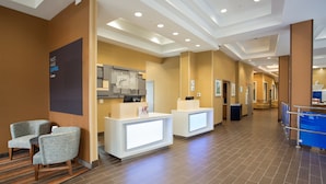 A hotel lobby with reception desks, seating area, and a modern ceiling design. - Holiday Inn Express Springfield Downtown by IHG (Springfield)