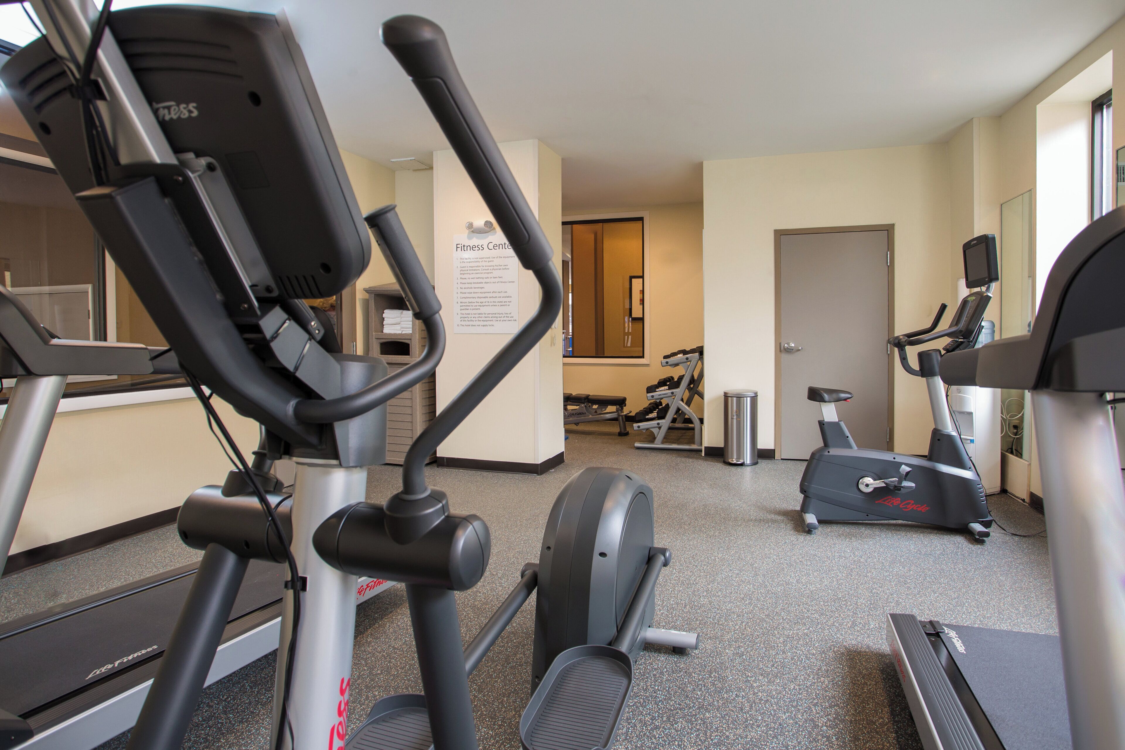 A fitness center with treadmills, an elliptical, and a stationary bike.