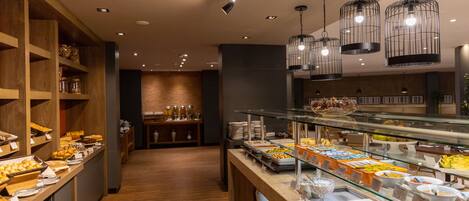 A buffet with various food items and a glass display case.