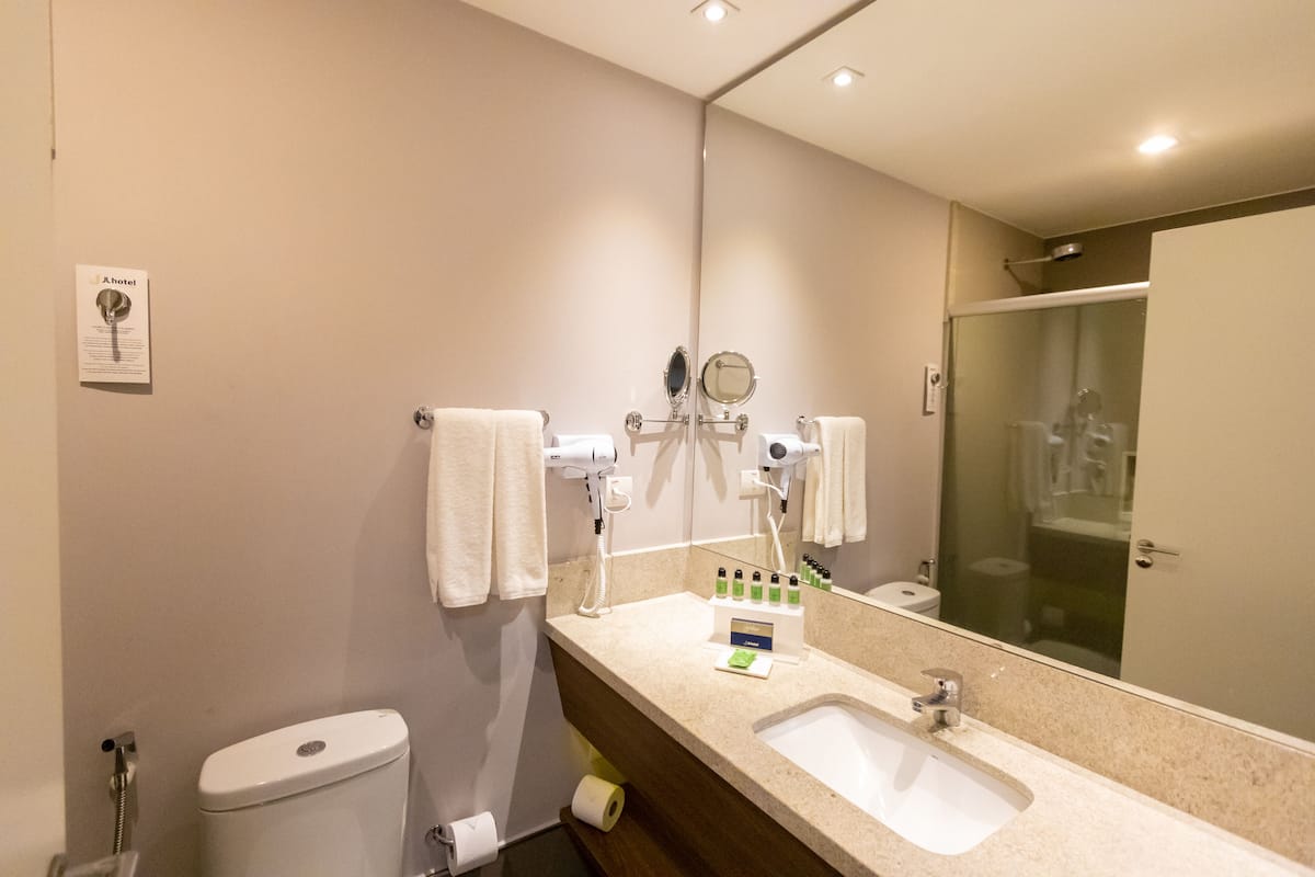 shower, designer toiletries, hair dryer, towels