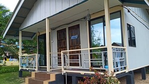 A two-story building with a covered porch and a small garden area in front. - Tamara Resort (Tioman Island)