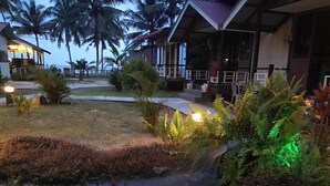 A resort with a pool, palm trees, and a well-lit outdoor area. - Tamara Resort (Tioman Island)