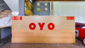 A wooden sign with the word "OYO" in red letters.