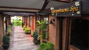 A spa entrance with a wooden deck, potted plants, and a sign reading "Timiryisaya Spa". - Sakura Inn (Nyaung-U)