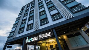 A hotel with a modern facade, multiple floors, and a prominent entrance with a sign. - InHotel Inanam Kota Kinabalu (Kota Kinabalu)