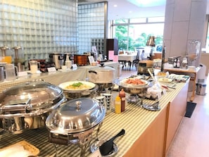 A buffet setup with various food items and condiments. - Yokote Central Hotel (Yokote)