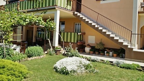 A two-story house with a balcony, a staircase, and a garden. - Apartments Palma (Rovinj)