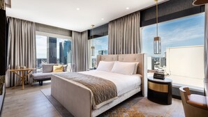 A modern hotel room with a large bed, a seating area, and a view of the cityscape. - InterContinental Perth City Centre by IHG (Perth)