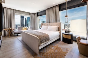 A modern hotel room with a large bed, a seating area, and a view of the cityscape. - InterContinental Perth City Centre by IHG (Perth)