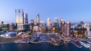 A city skyline with modern high-rise buildings, a waterfront promenade, and a bridge. - InterContinental Perth City Centre by IHG (Perth)