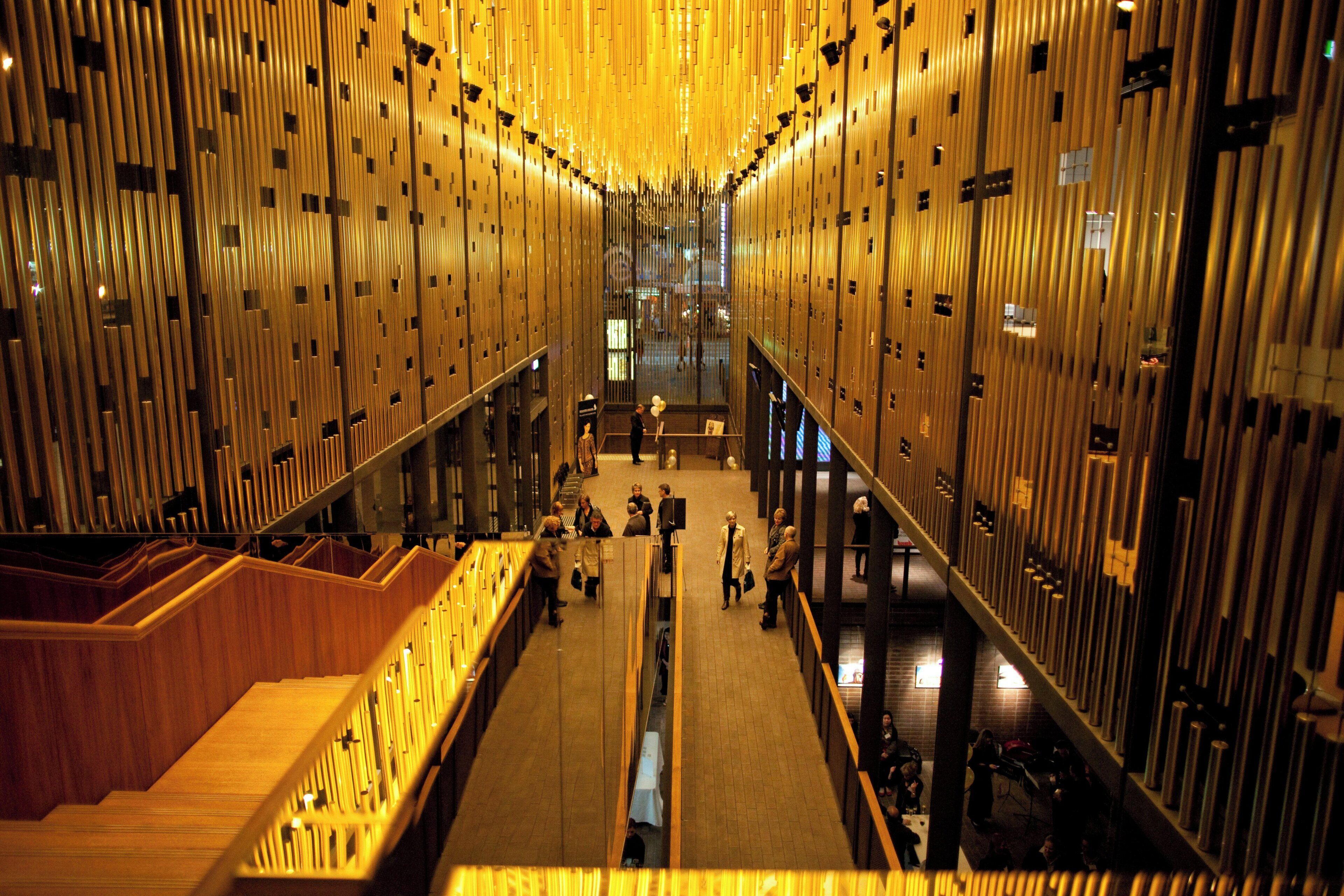 A spacious interior with a central walkway flanked by vertical wooden panels.