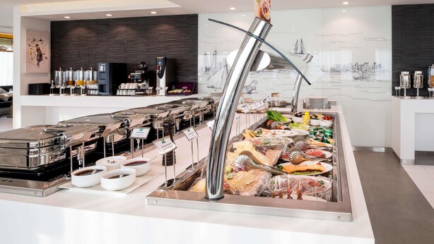 A buffet setup with various food items and a coffee station. - ibis Styles Manama Diplomatic Area (Manama)