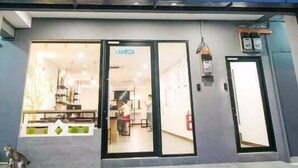 The exterior of an Urban Inn hotel with a modern design, featuring a prominent illuminated sign and large windows. - Urban Inn, Jitra (Jitra)