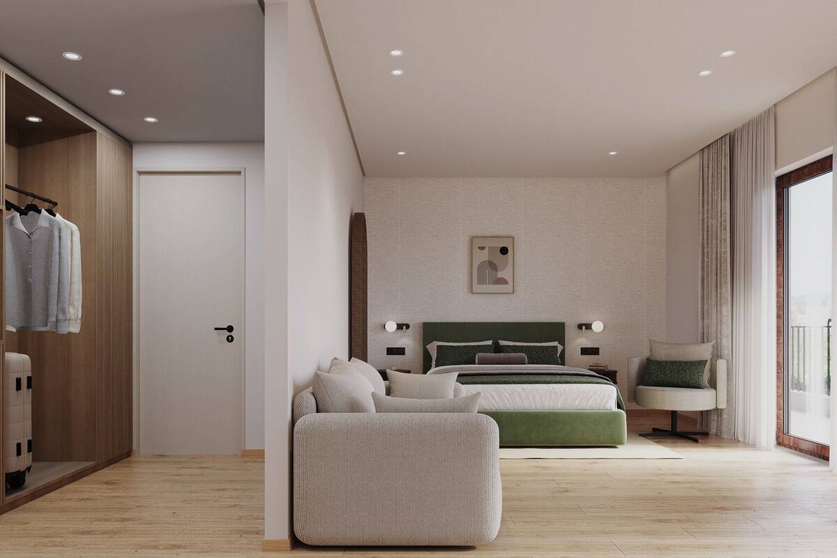A modern bedroom with a bed, a sofa, a chair, and a wardrobe.