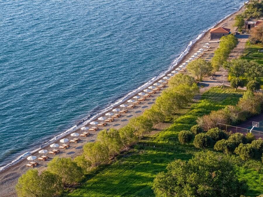 On the beach, black sand, sun loungers, beach umbrellas