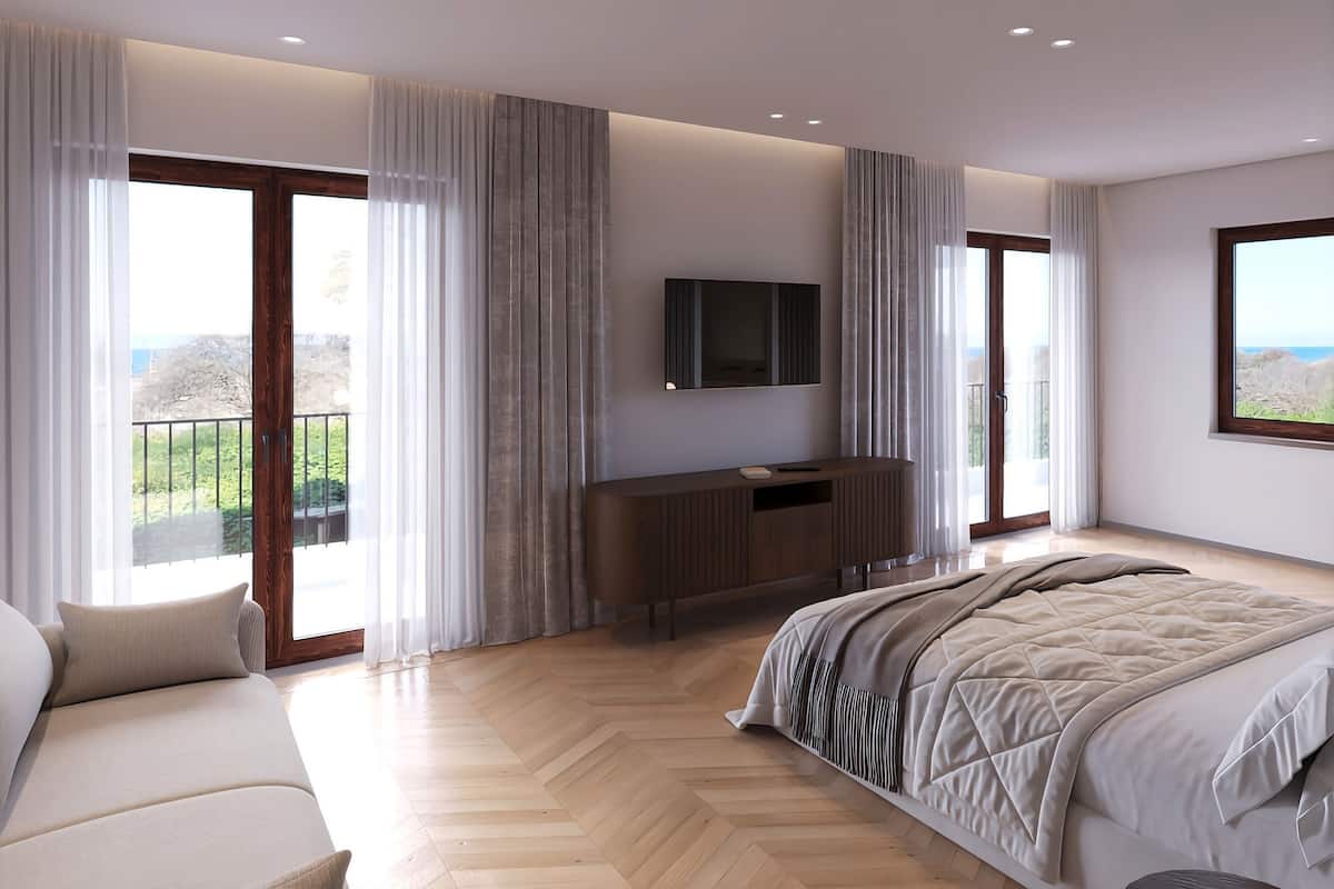 A modern bedroom with a large bed, a sofa, a TV, and a balcony with a view.