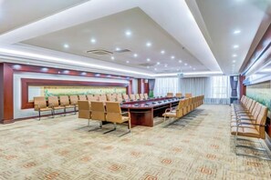 A conference room with a long table and chairs, carpeted floor, and a large painting on the wall. - Longyuan Northern Base (Yichun)