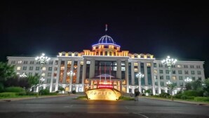 A large, well-lit building with a prominent dome and a central entrance. - Longyuan Northern Base (Yichun)