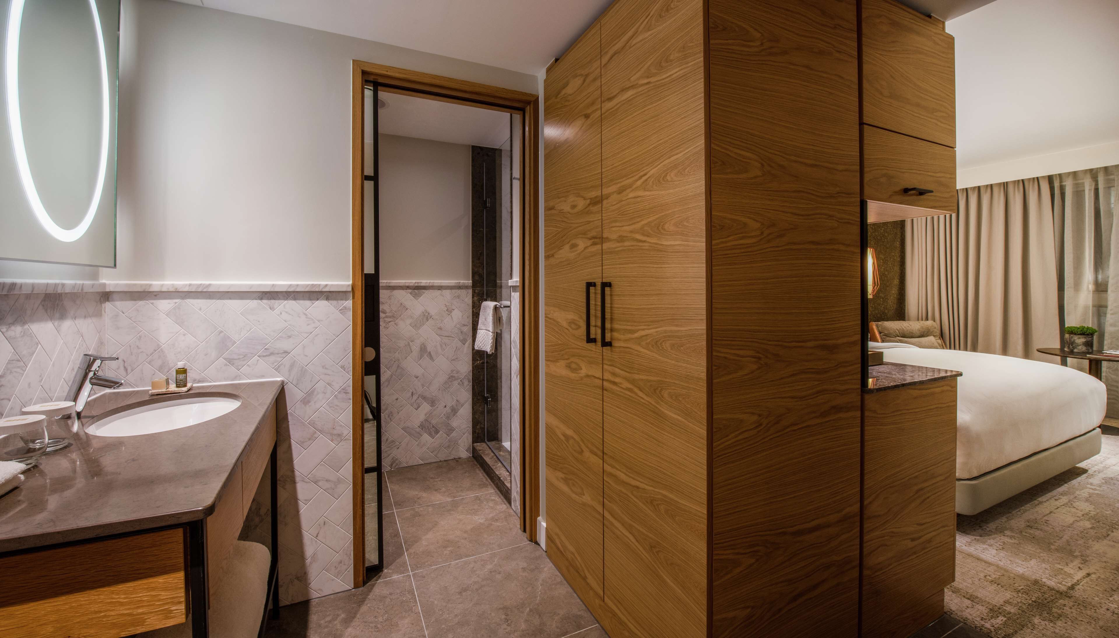 guest room with canary wharf view | bathroom | shower, rainfall showerhead, designer toiletries, hair dryer