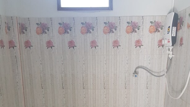 A bathroom with a toilet, a shower, and a window. - Koh Sichang Unseen (Ko Sichang)