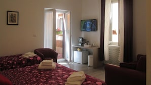 A hotel room with two beds, a desk, a TV, and a balcony. - Trevi Elegance Suite (Rome)