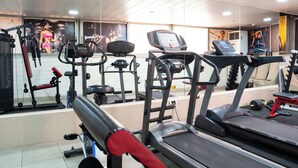 A gym with various exercise equipment including treadmills, weight machines, and free weights. - Grand Concerto Hotel (Beirut)