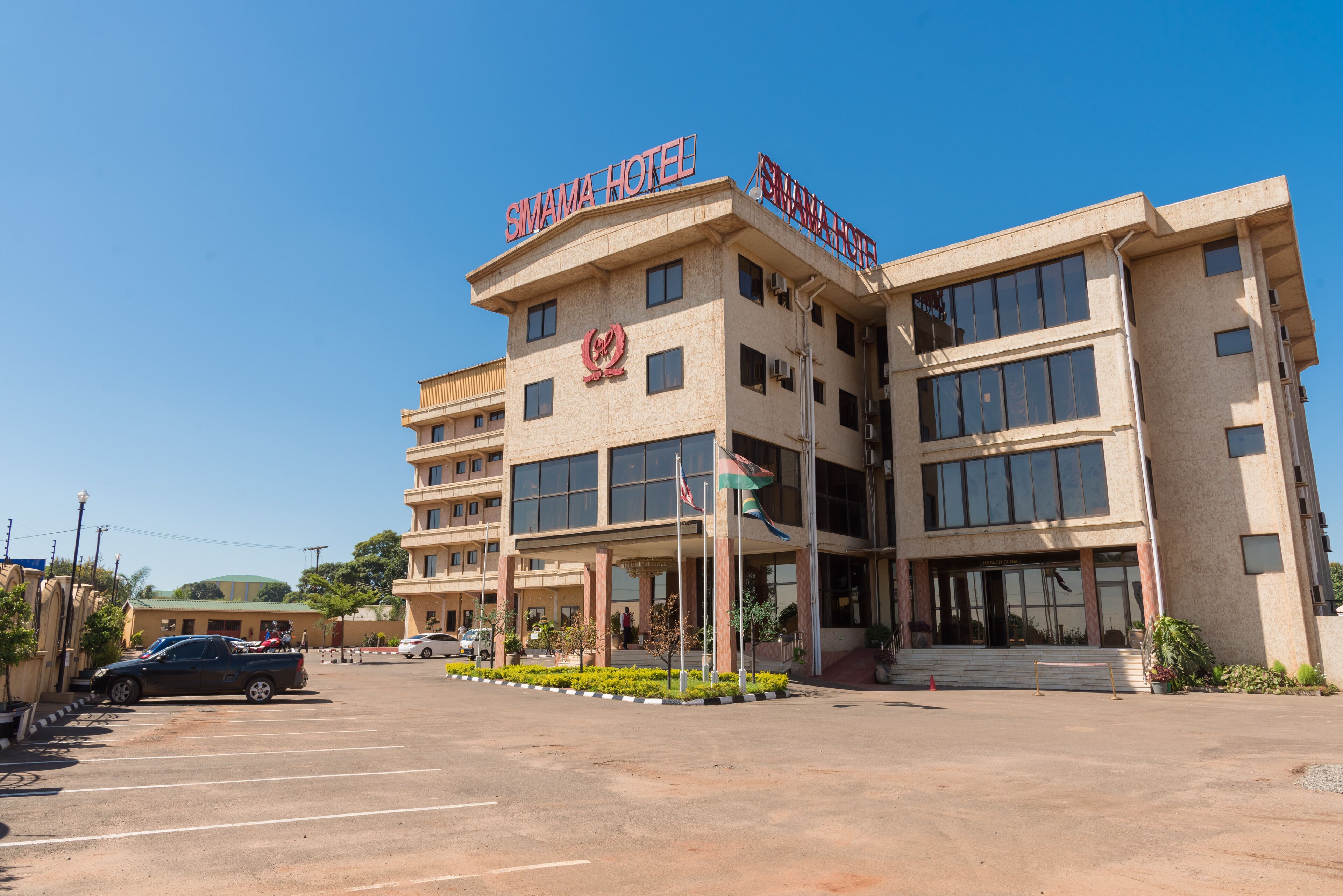 A multi-story hotel with a prominent sign reading "SIMAMA HOTEL".