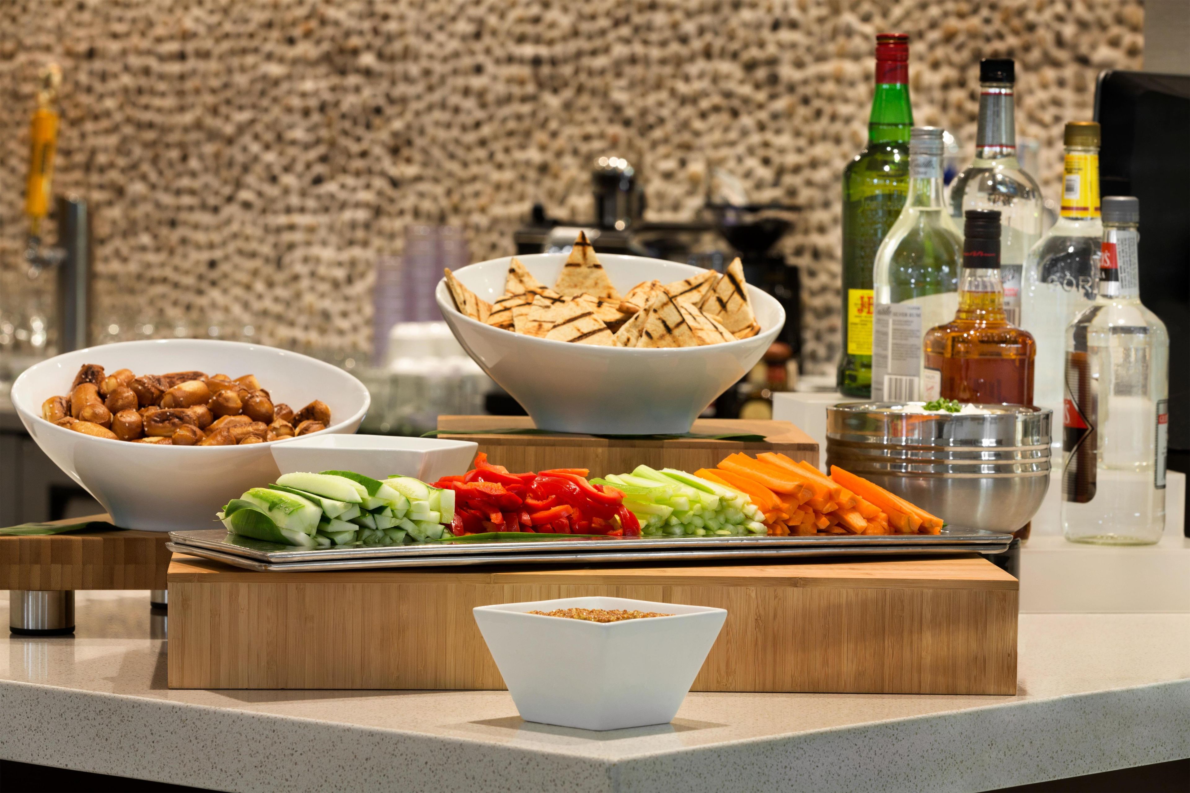 A buffet table with various food items and condiments.