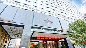 A high-rise hotel with a modern facade, large windows, and a prominent entrance with signage. - Lamtin Longwin Hotel Wuhan (Wuhan)