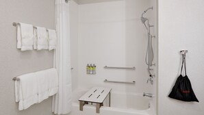 A modern bathroom with a walk-in shower, a bathtub, and a small wooden stool. - Holiday Inn Express & Suites Plano East - Richardson by IHG (Plano)
