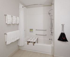 A modern bathroom with a walk-in shower, a bathtub, and a small wooden stool. - Holiday Inn Express & Suites Plano East - Richardson by IHG (Plano)