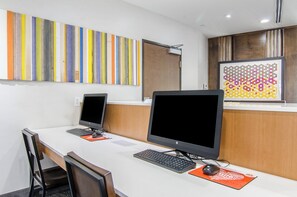 A workspace with two HP monitors, a keyboard, and a mouse on a white desk. - Holiday Inn Express & Suites Atchison by IHG (Atchison)