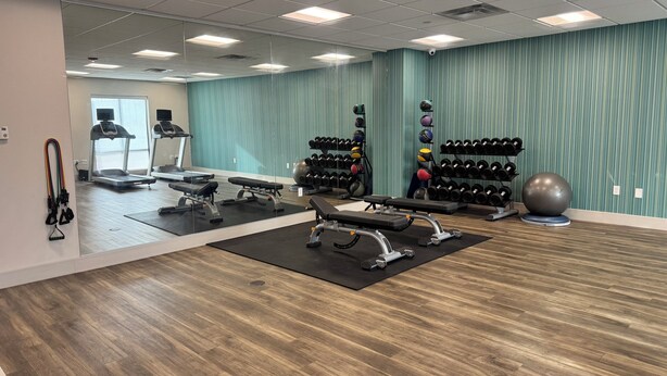 A gym with treadmills, weight benches, and various exercise equipment. - Holiday Inn Express & Suites Atchison by IHG (Atchison)