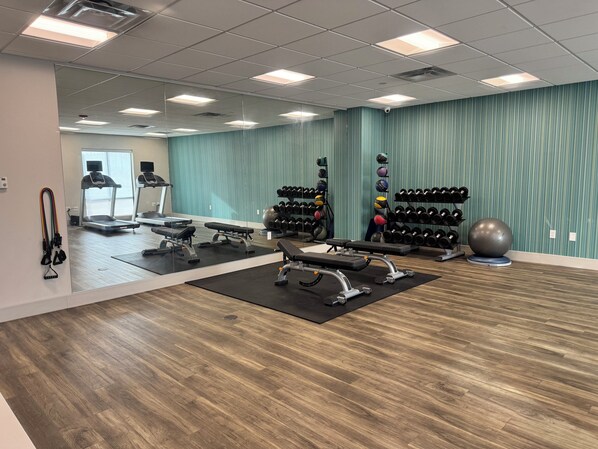 A gym with treadmills, weight benches, and various exercise equipment. - Holiday Inn Express & Suites Atchison by IHG (Atchison)
