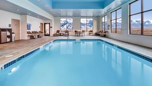 A swimming pool with a view of mountains through large windows. - Hampton Inn & Suites Wells (Wells)