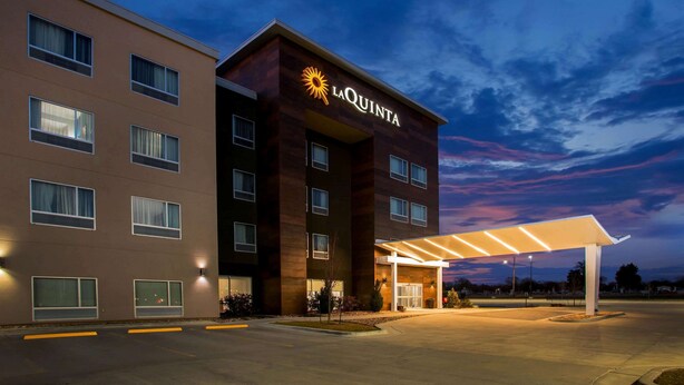 A hotel with a modern design, featuring a prominent 'La Quinta' sign and a covered entrance. - La Quinta Inn & Suites by Wyndham Pittsburg (Pittsburg)
