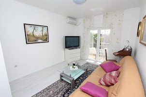 Apartment, 1 Bedroom, Balcony | Living area | TV