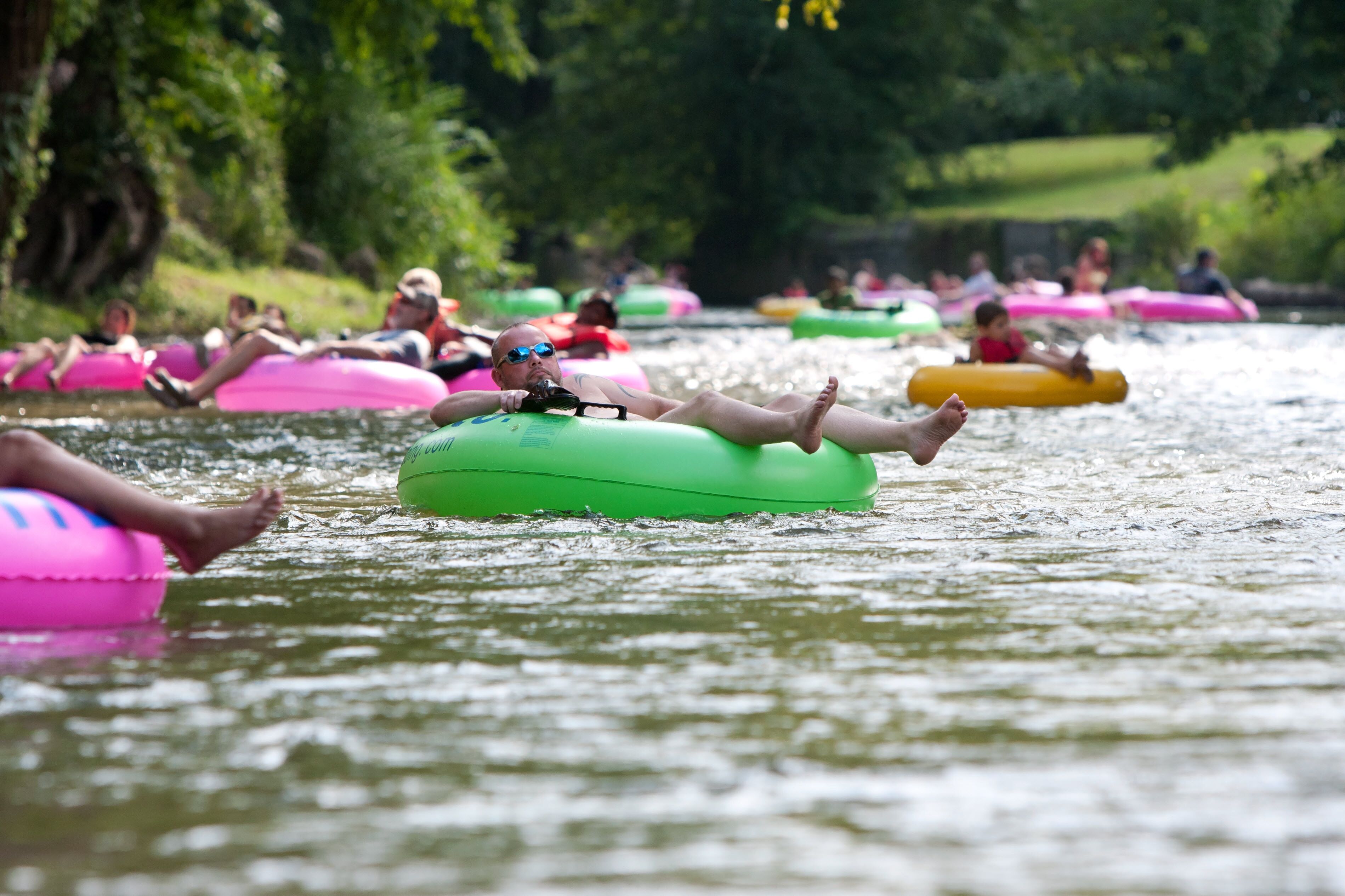 People floating on water in a park.