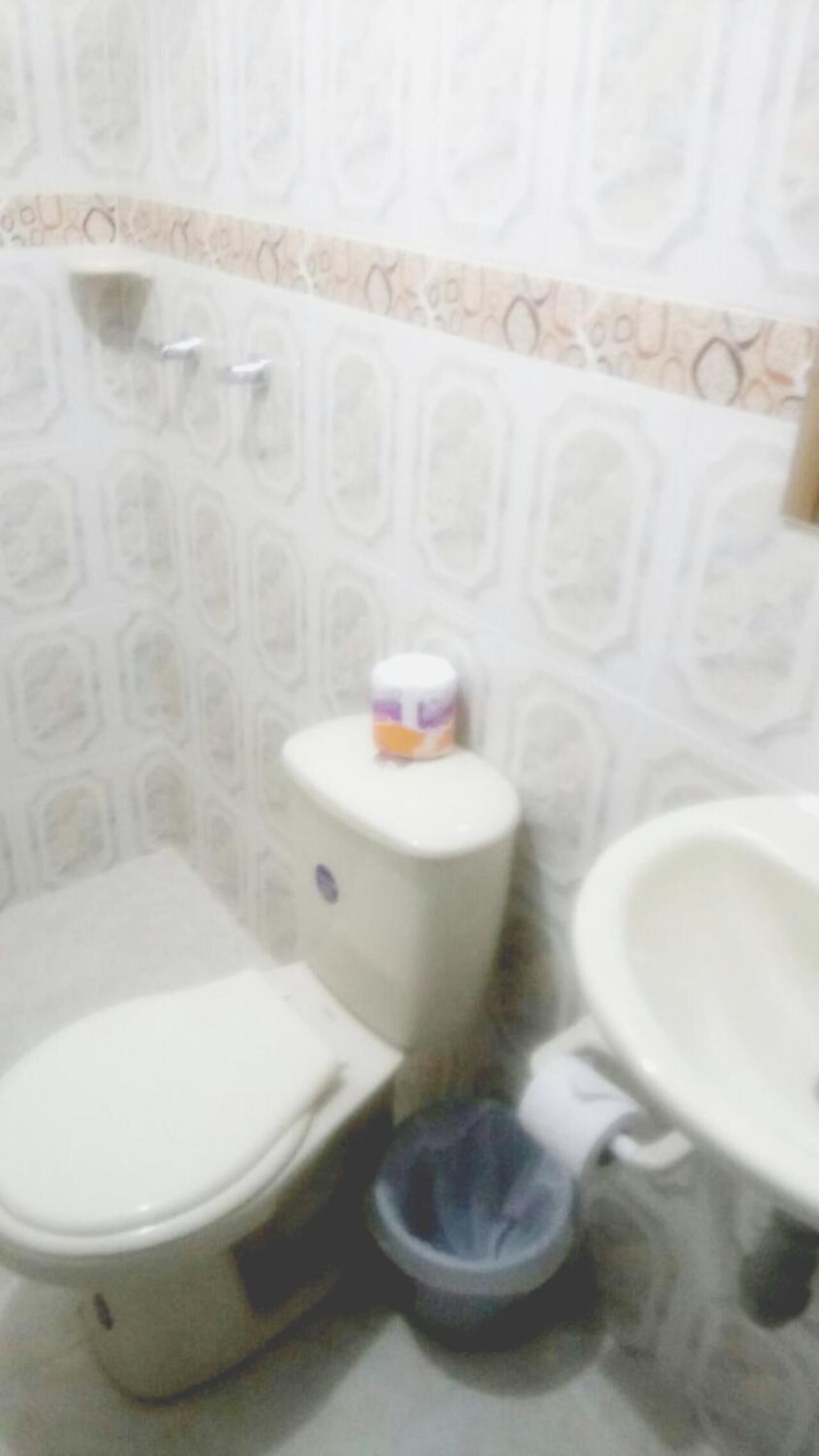 A bathroom with a toilet, bidet, and sink.