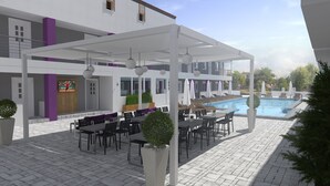An outdoor patio area with tables and chairs, a pool, and a covered seating area. - Philoxenia Earia (Volvi)