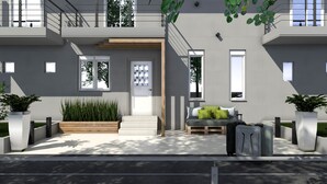 A modern two-story building with a flat roof, large windows, and a minimalist design. - Philoxenia Earia (Volvi)