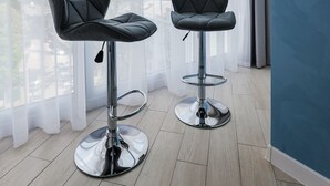 Two modern bar stools with chrome bases, positioned in front of a large window with sheer curtains. - CityApartments Kyiv Palace "Ukraine" (Kyiv)
