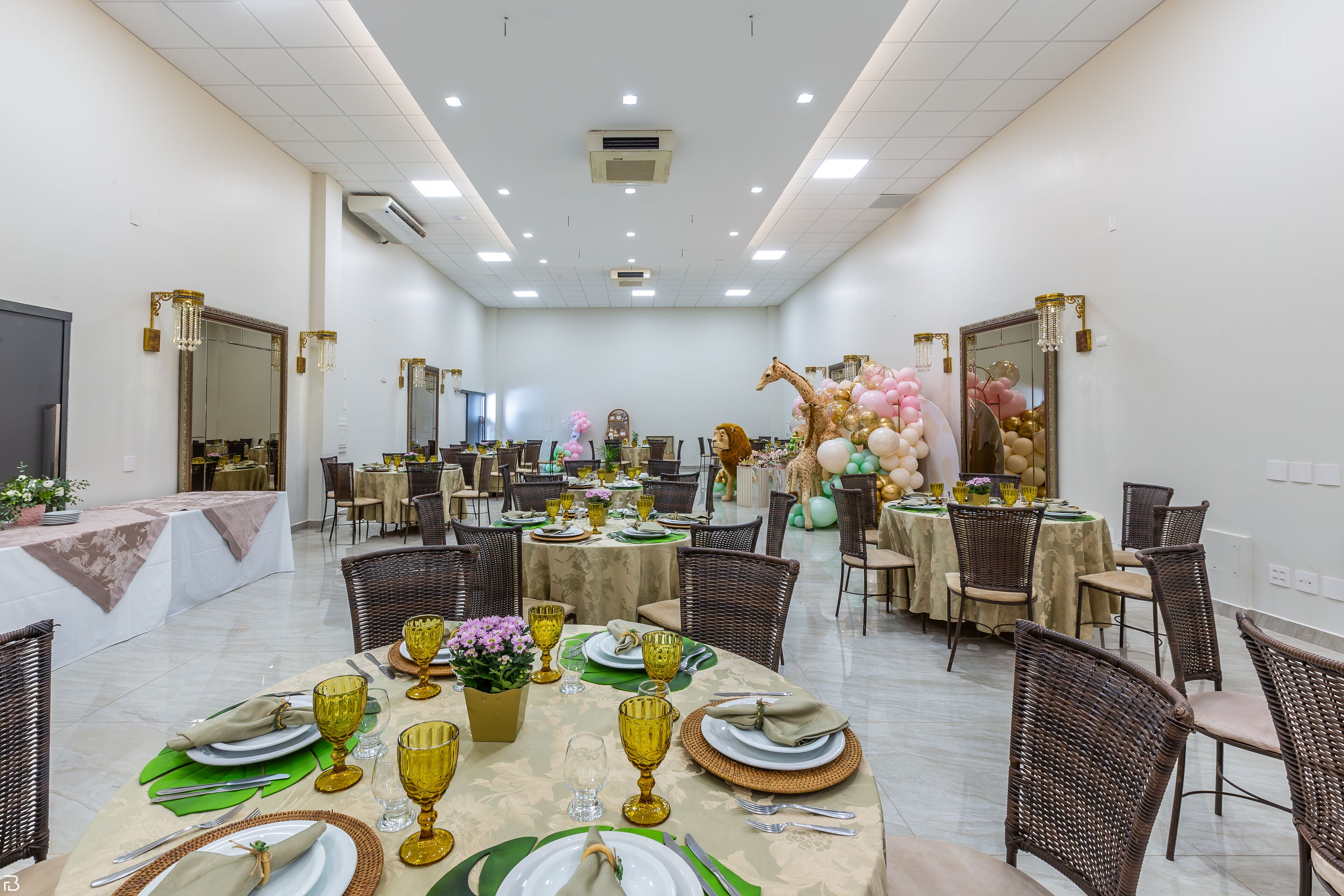 A spacious dining area with round tables, wicker chairs, and a central buffet.