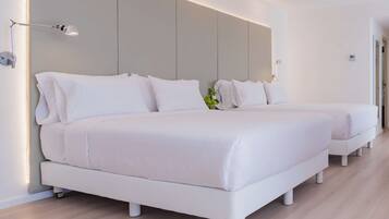 A modern hotel room with two white beds, a bedside table with a lamp, and a large wall-mounted panel.