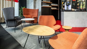 Una moderna zona relax con un bar, posti a sedere e una televisione.
